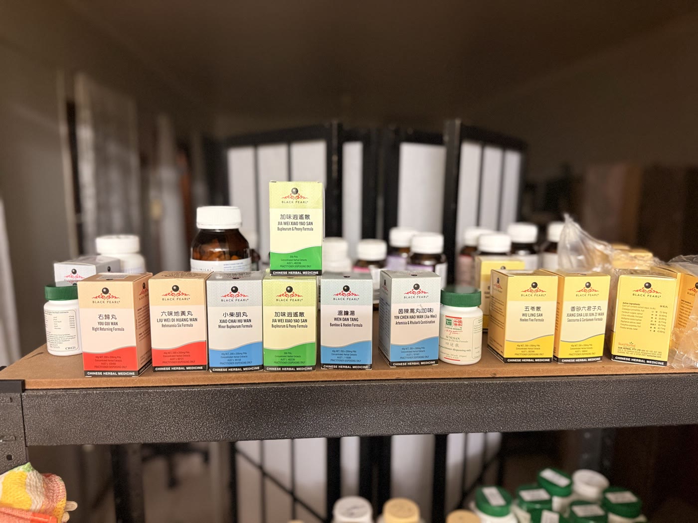 The dispensary shelves, lined with labelled Chinese herbal formulas