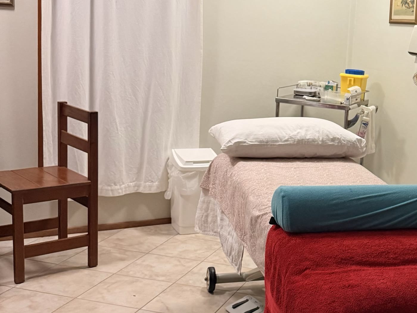 A second view of the treatment room, showing the table, bolster and side table